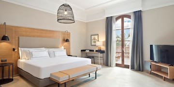 a bedroom with a bed and a bench