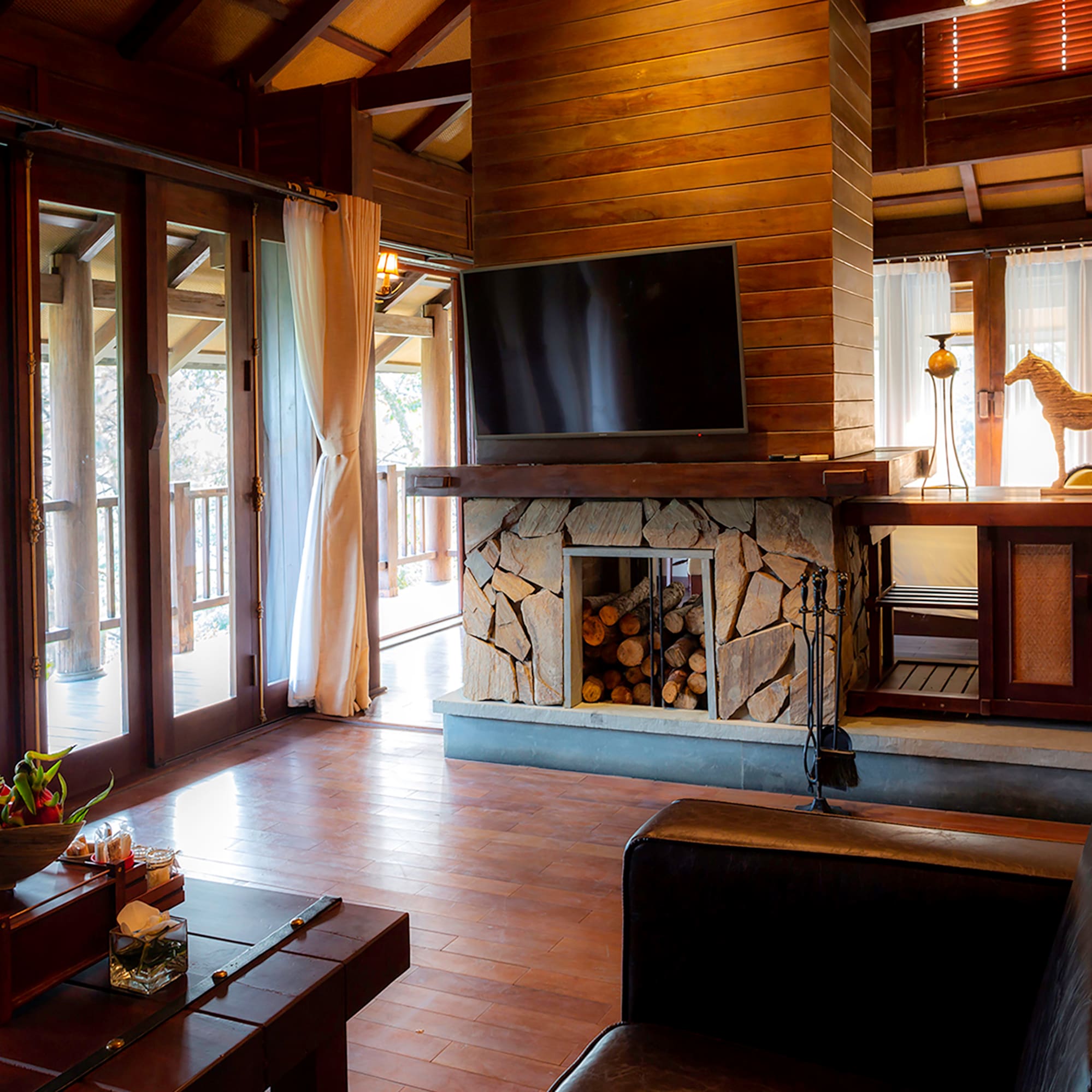 a living room with a fireplace and a television