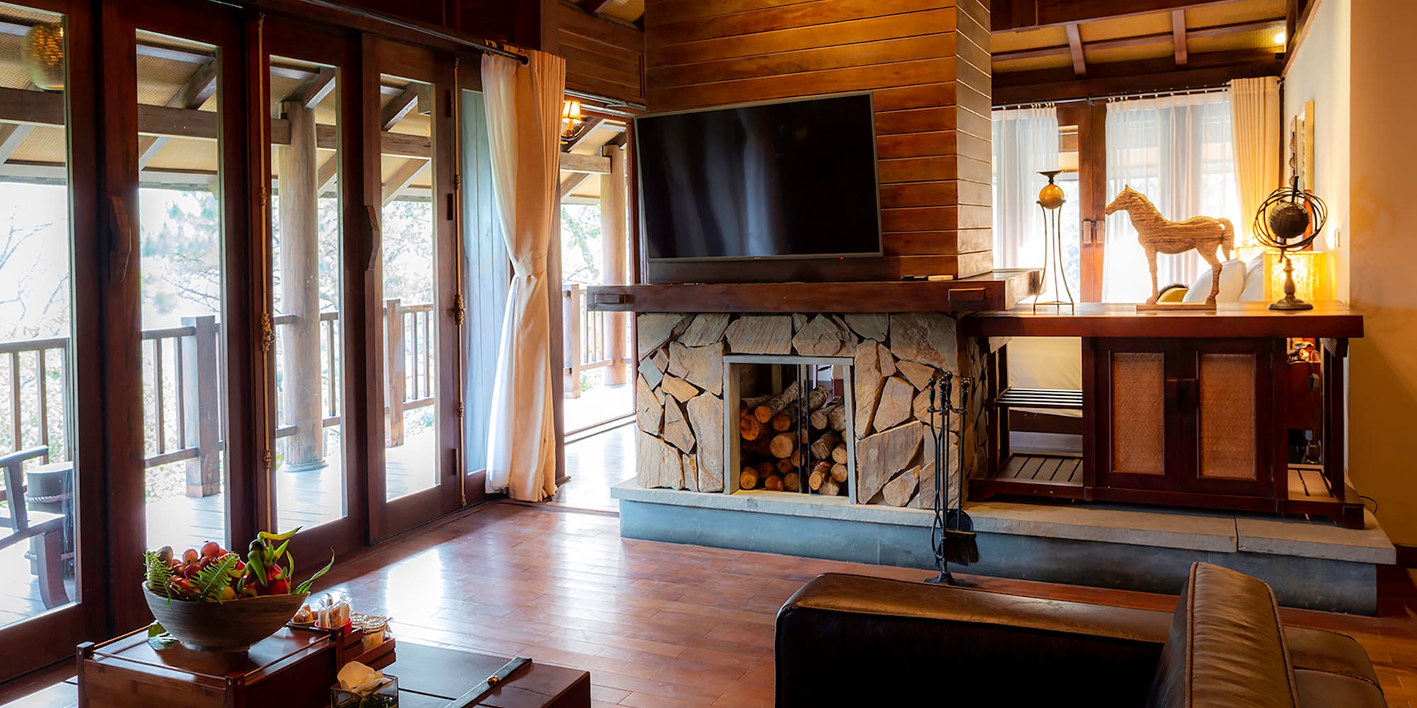a living room with a fireplace and a television