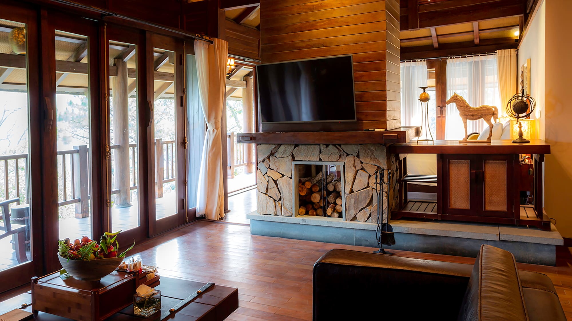 a living room with a fireplace and a television