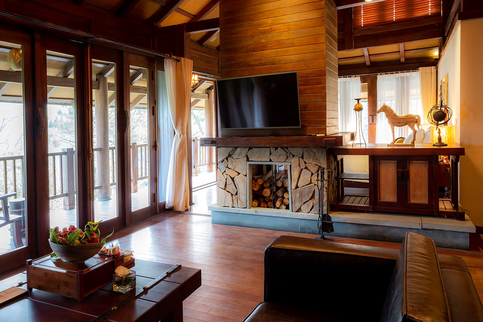 a living room with a fireplace and a television