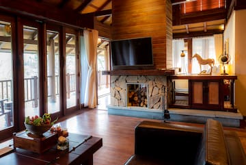 a living room with a fireplace and a television