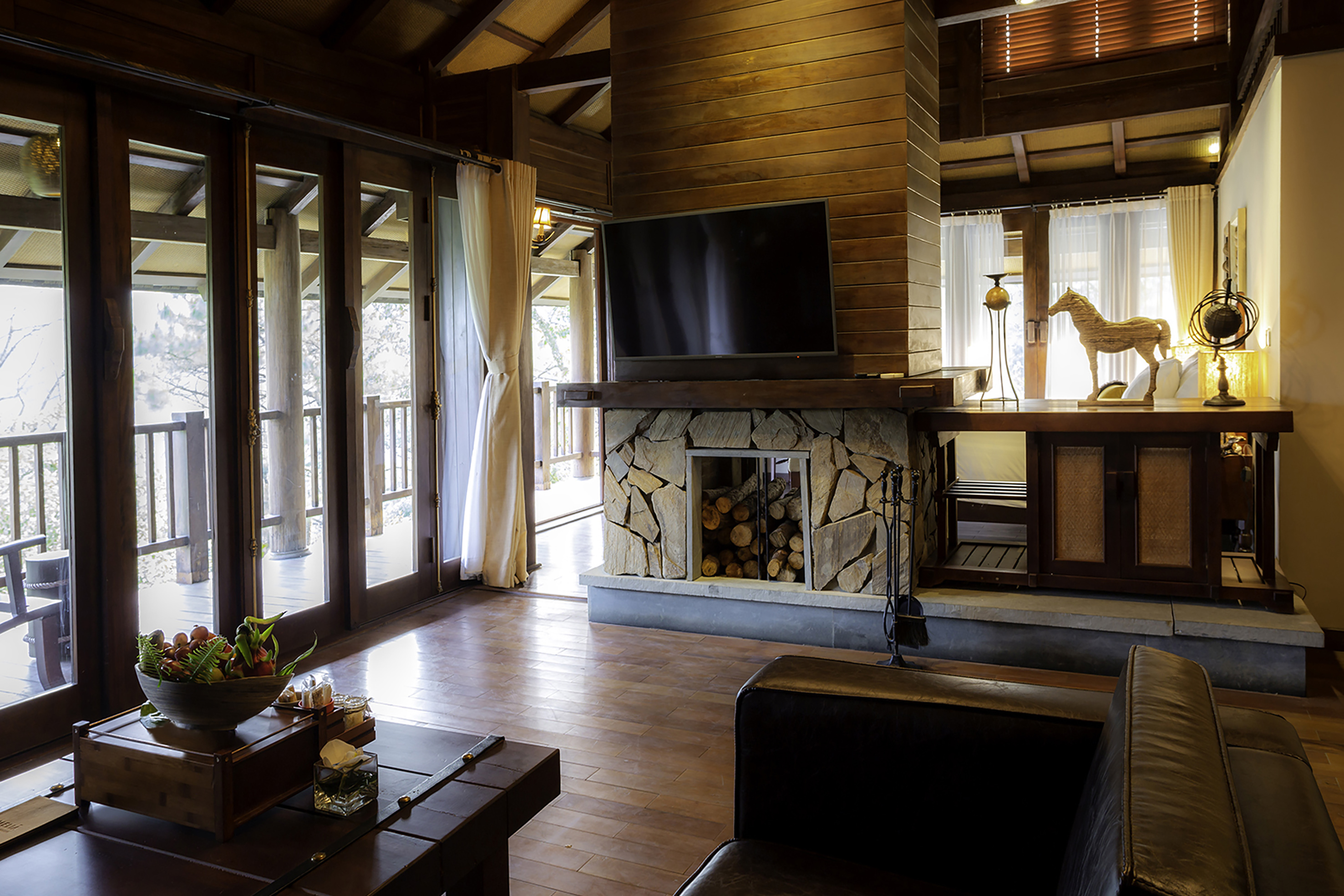 a living room with a fireplace and a television