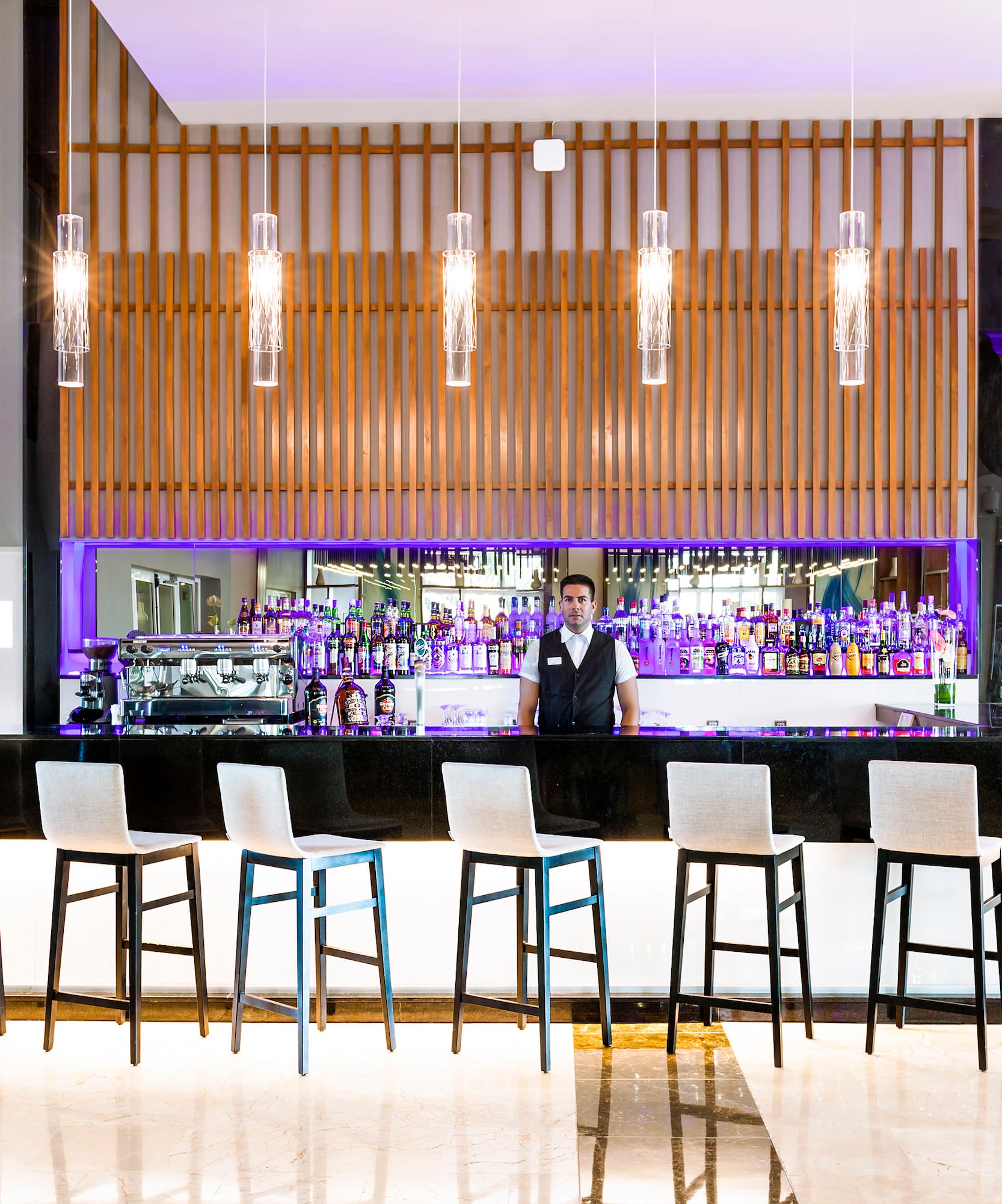 a man standing behind a bar