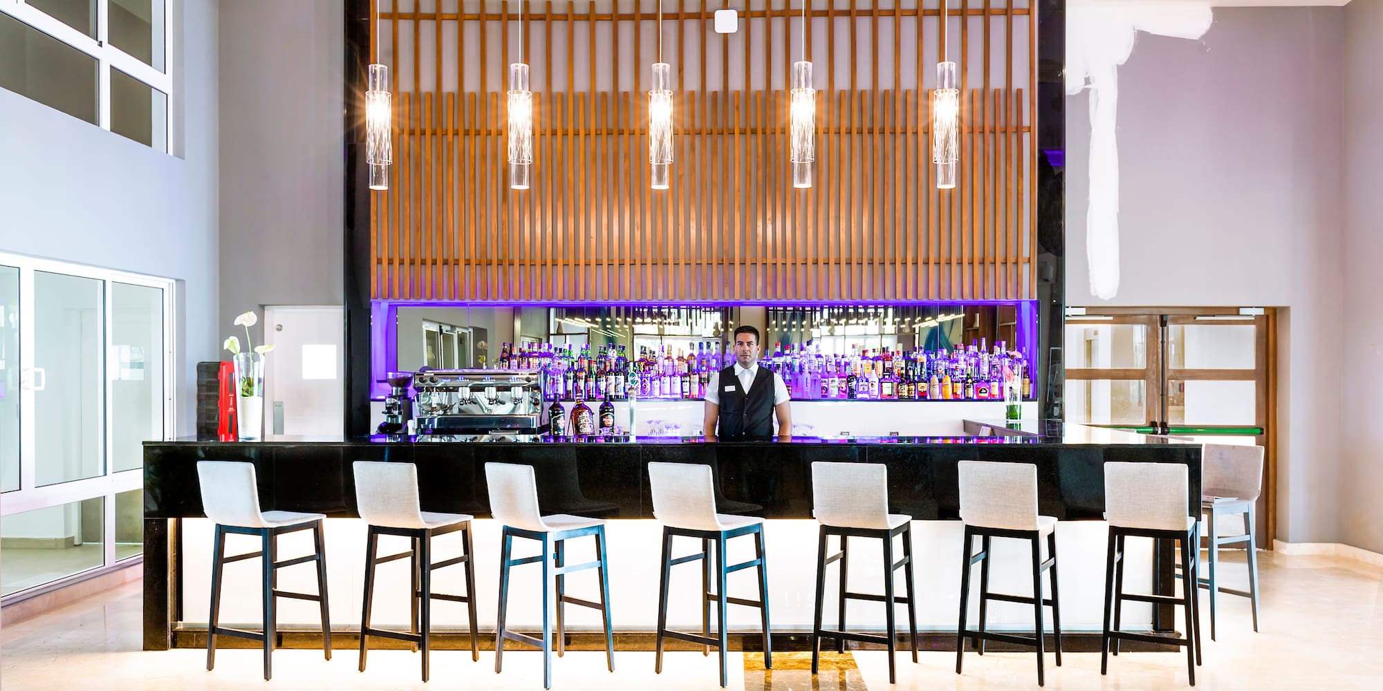 a man standing behind a bar