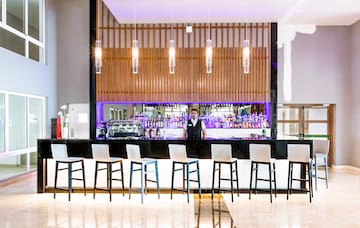 a man standing behind a bar