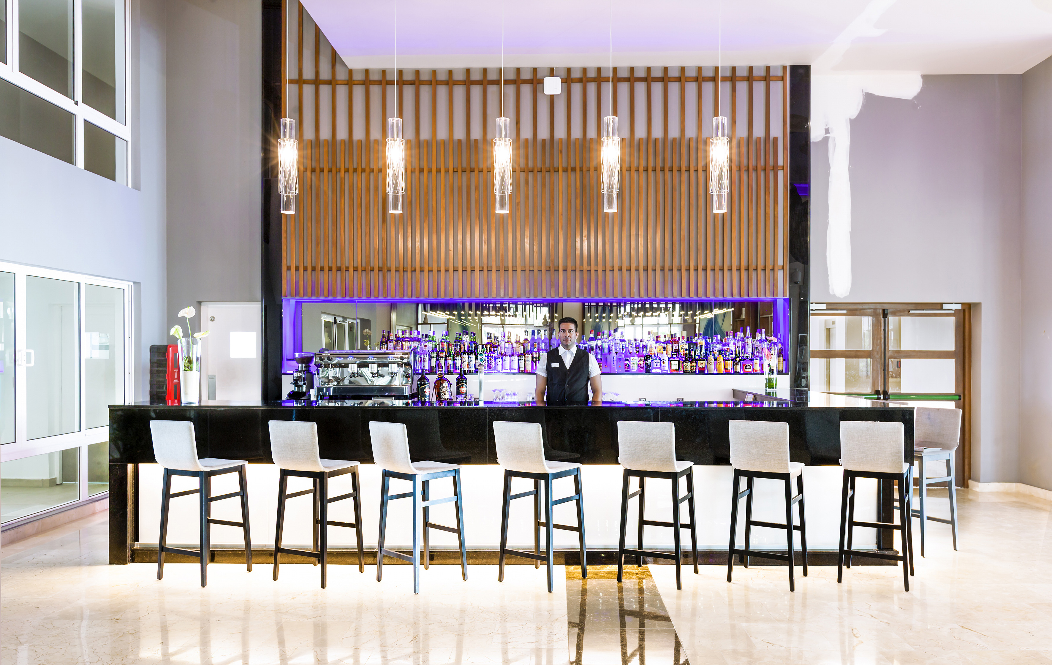 a man standing behind a bar