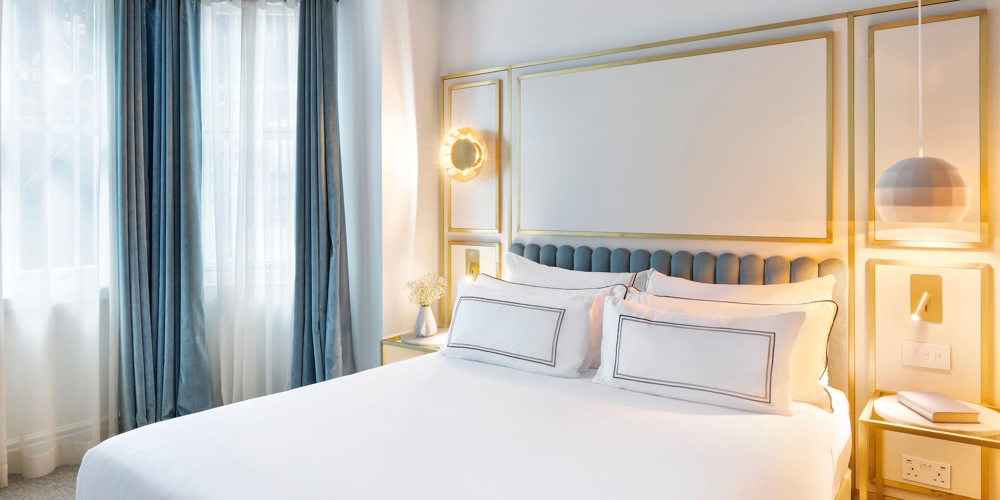 a bed with white sheets and pillows