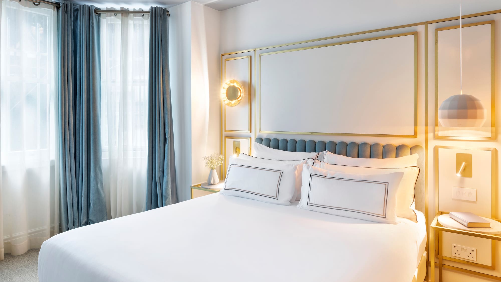 a bed with white sheets and pillows