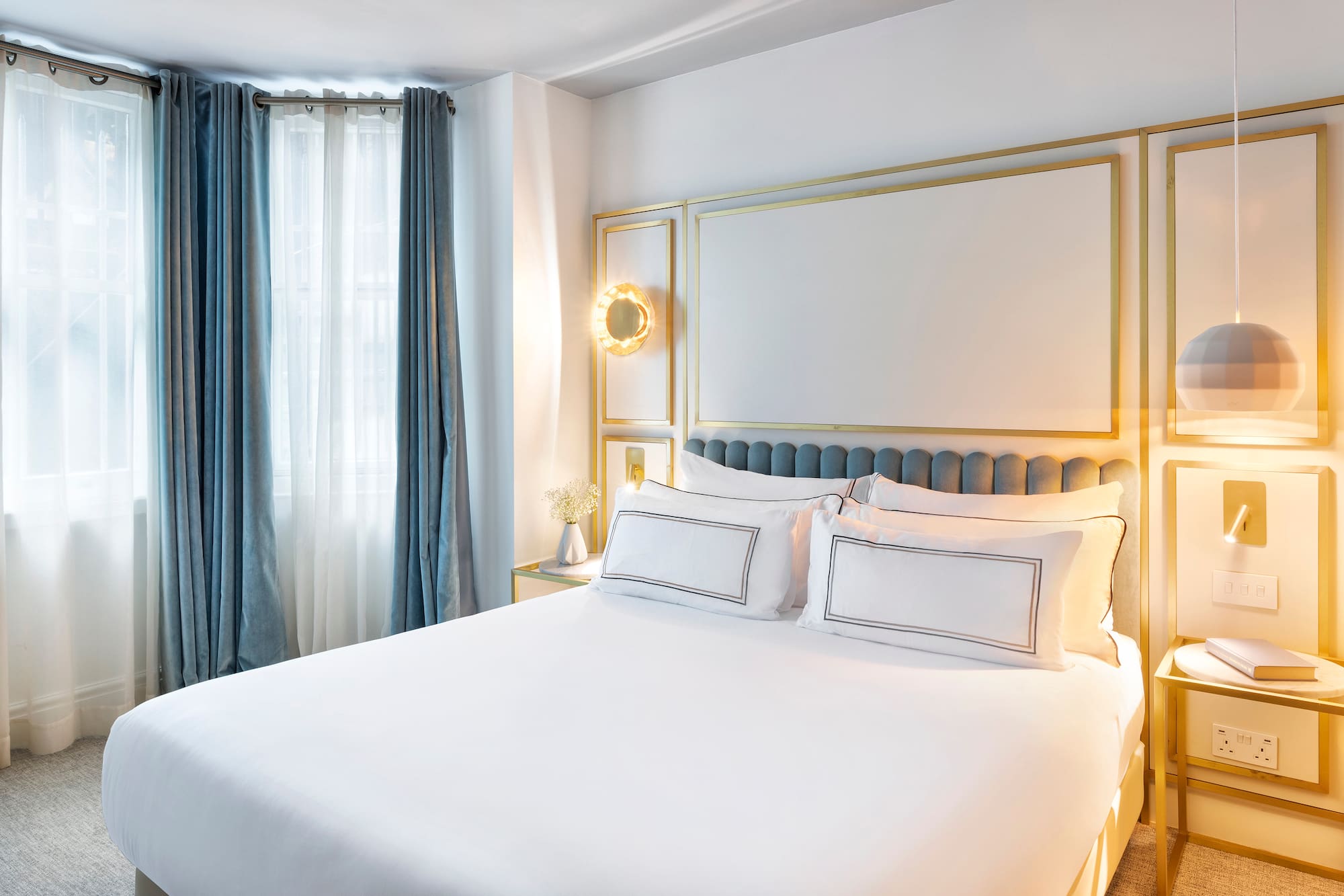 a bed with white sheets and pillows