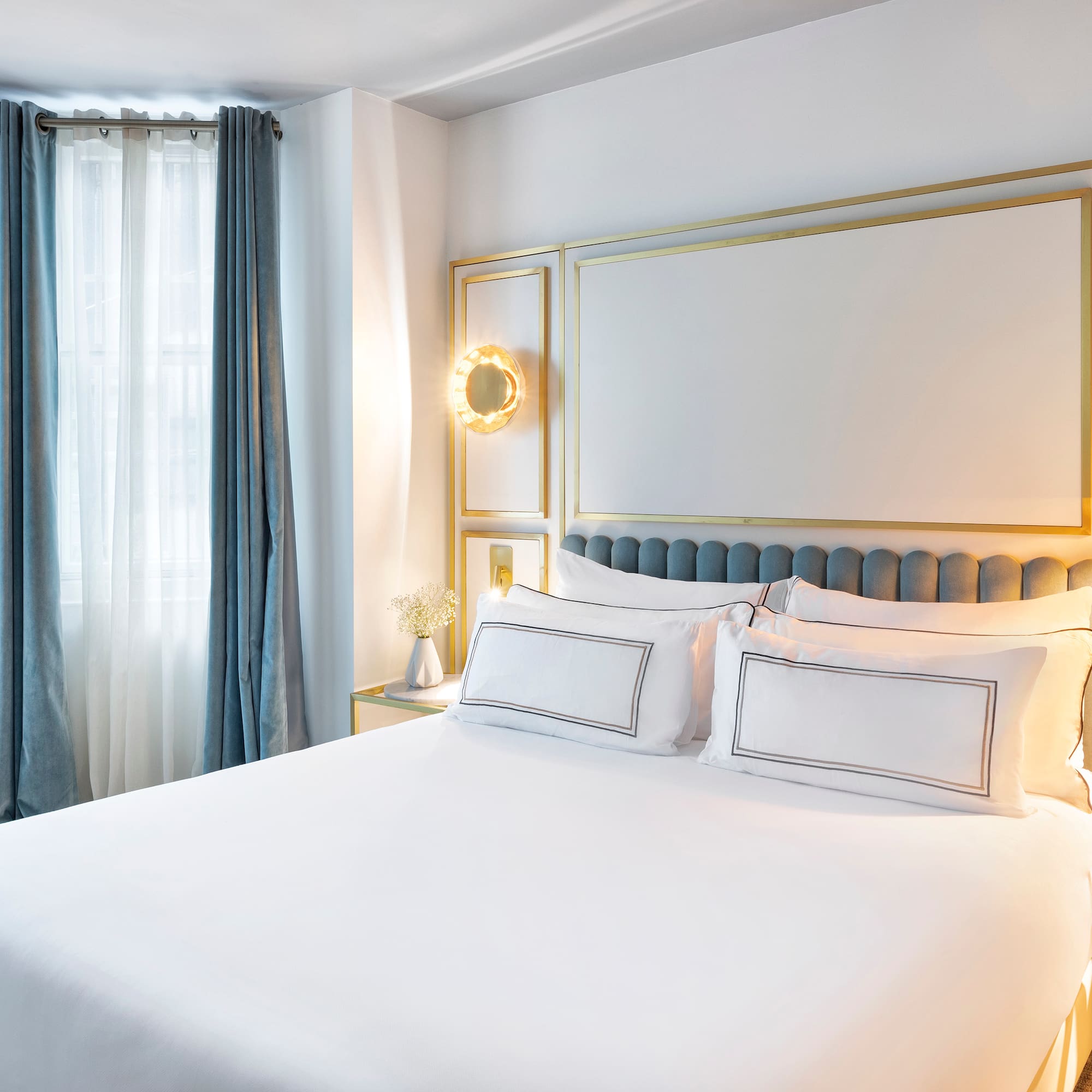 a bed with white sheets and pillows