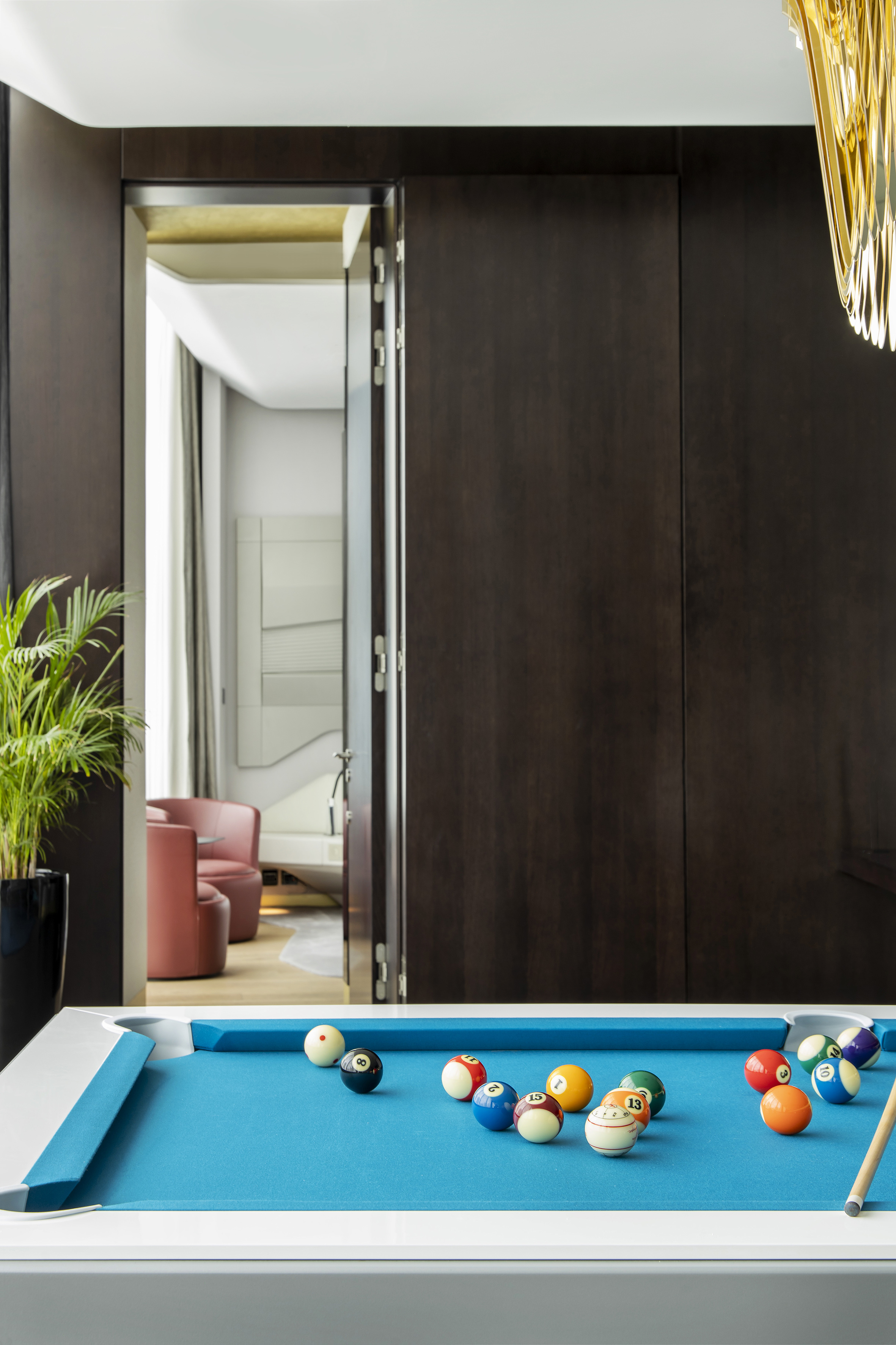 Modern blue pool table with billiard balls in a luxury game room.