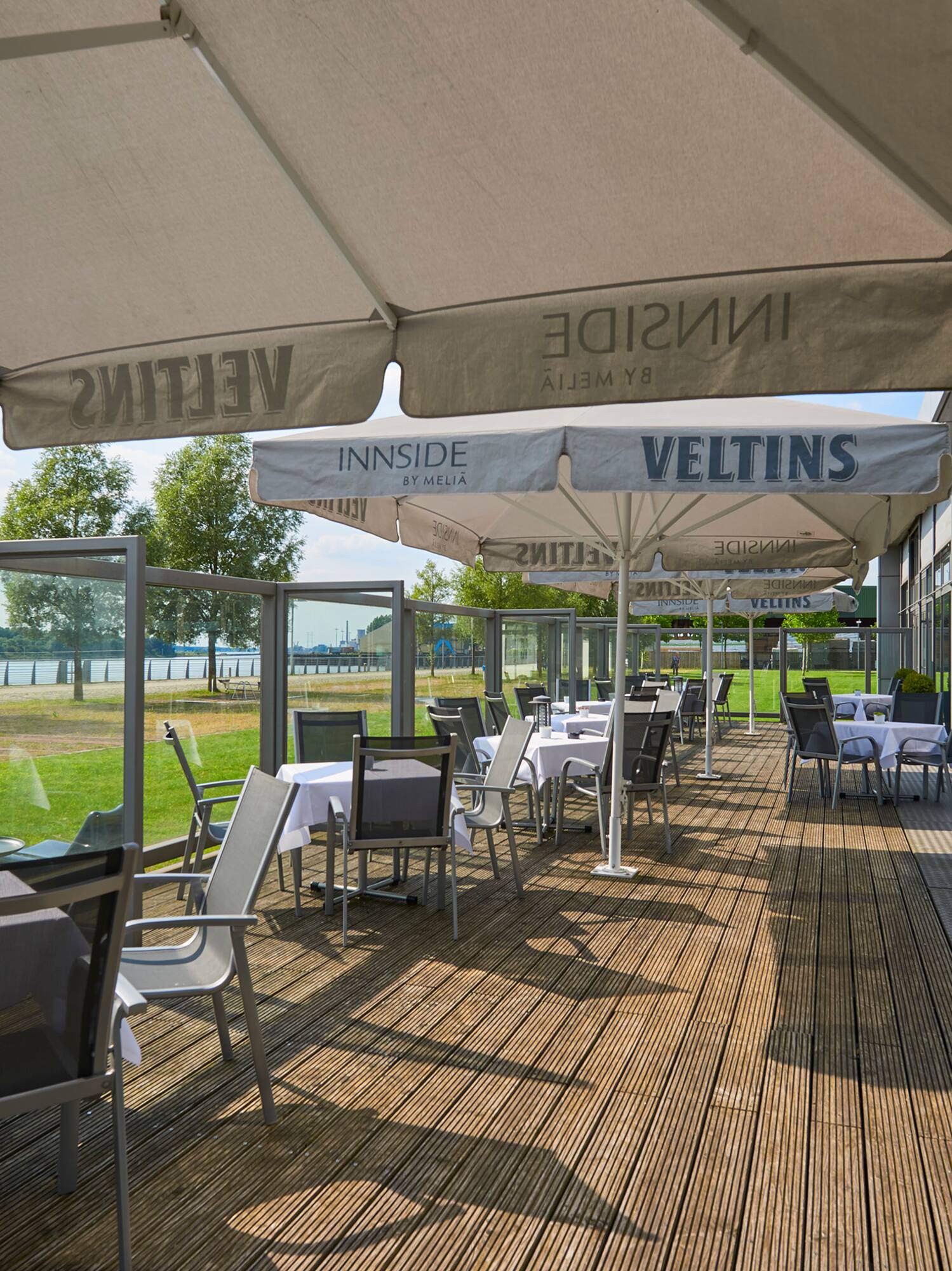a patio with tables and umbrellas