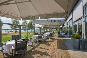 a patio with tables and umbrellas