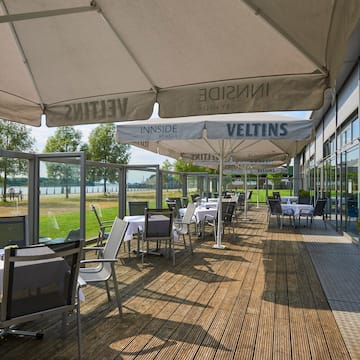 a patio with tables and umbrellas