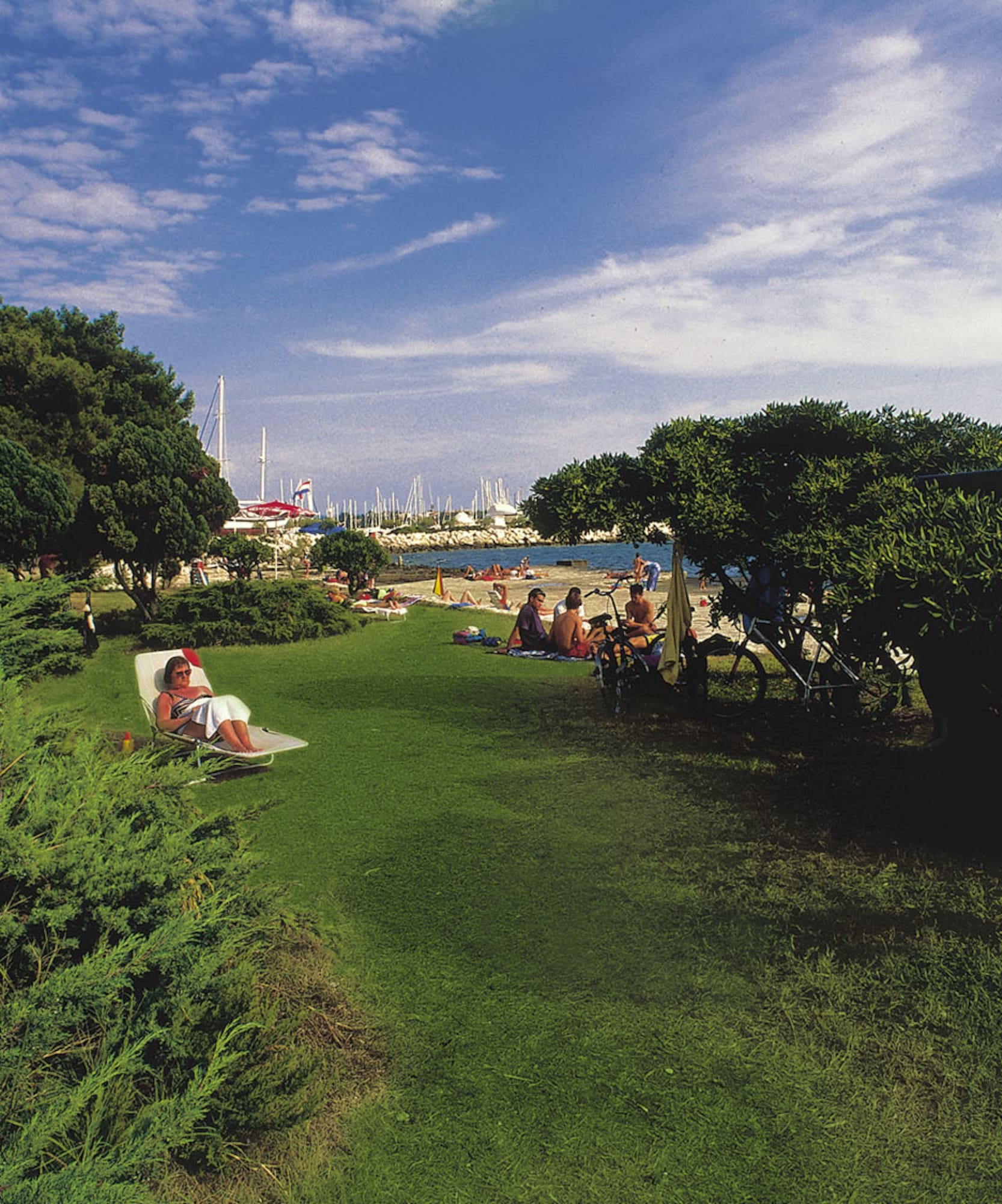 a group of people sitting in chairs on a lawn