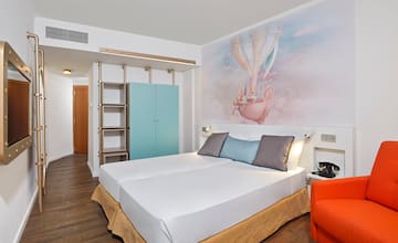 a bed with a picture on the wall