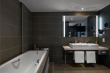 a bathroom with a bathtub and a mirror