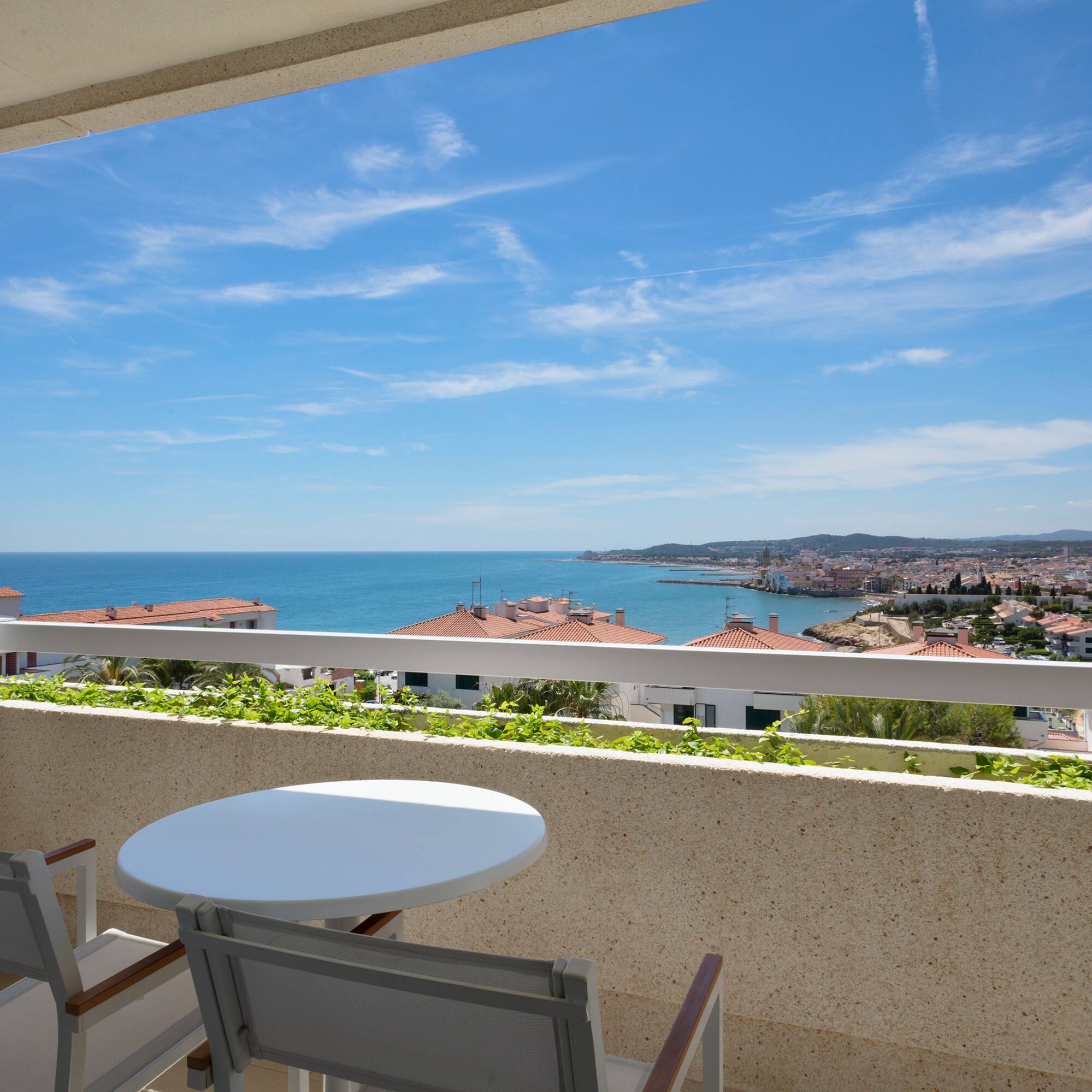 a table and chairs overlooking a body of water