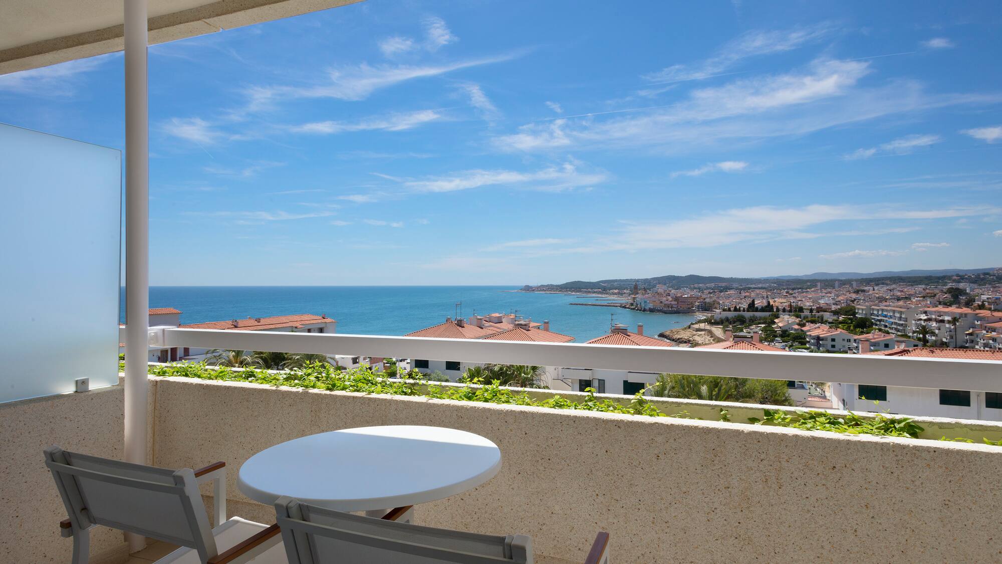 a table and chairs overlooking a body of water