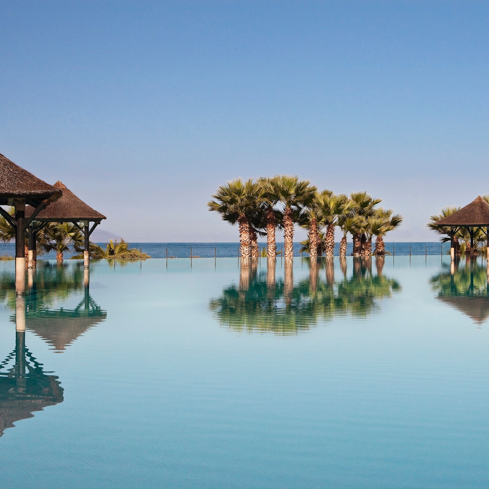 a pool with trees and a gazebo