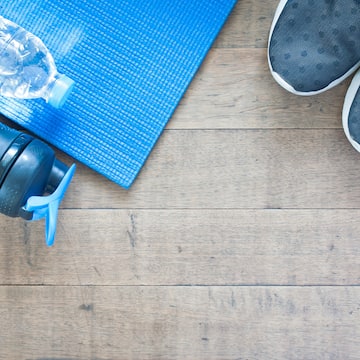 a blue mat and water bottle on a wooden floor