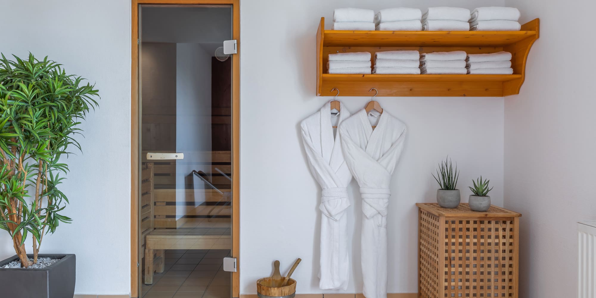 a room with white bathrobes and towels