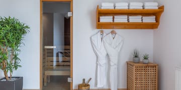 a room with white bathrobes and towels