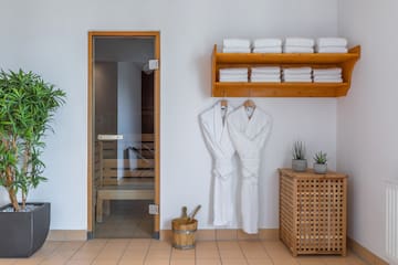 a room with white bathrobes and towels