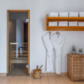a room with white bathrobes and towels