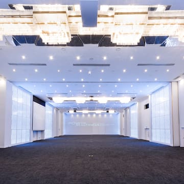 a room with a large ceiling and a screen