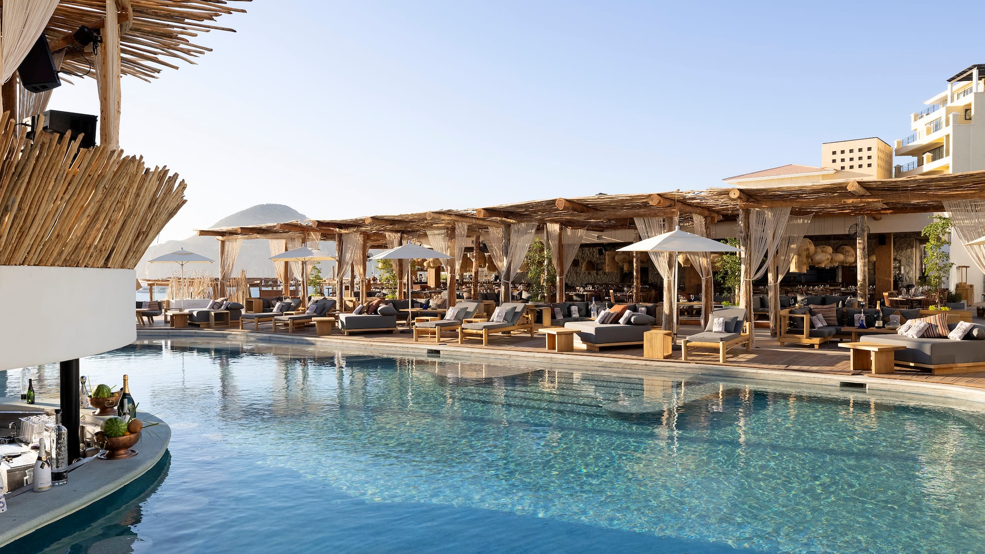 a pool with lounge chairs and umbrellas