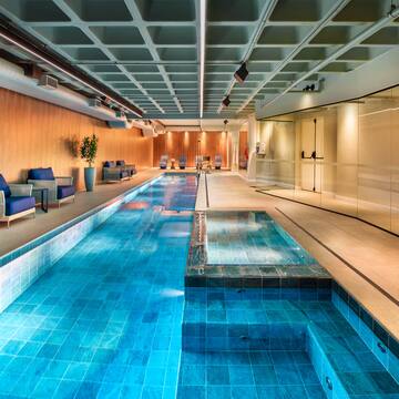 a indoor swimming pool with a large rectangular pool