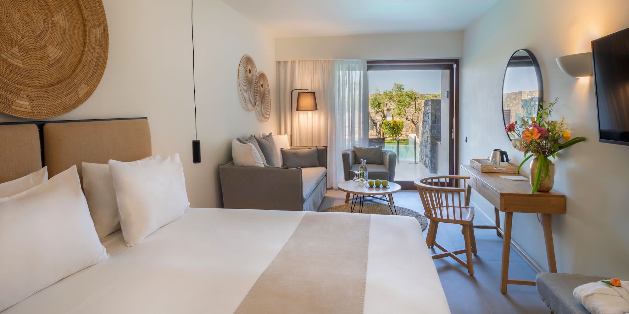 a room with a bed and a table and chair