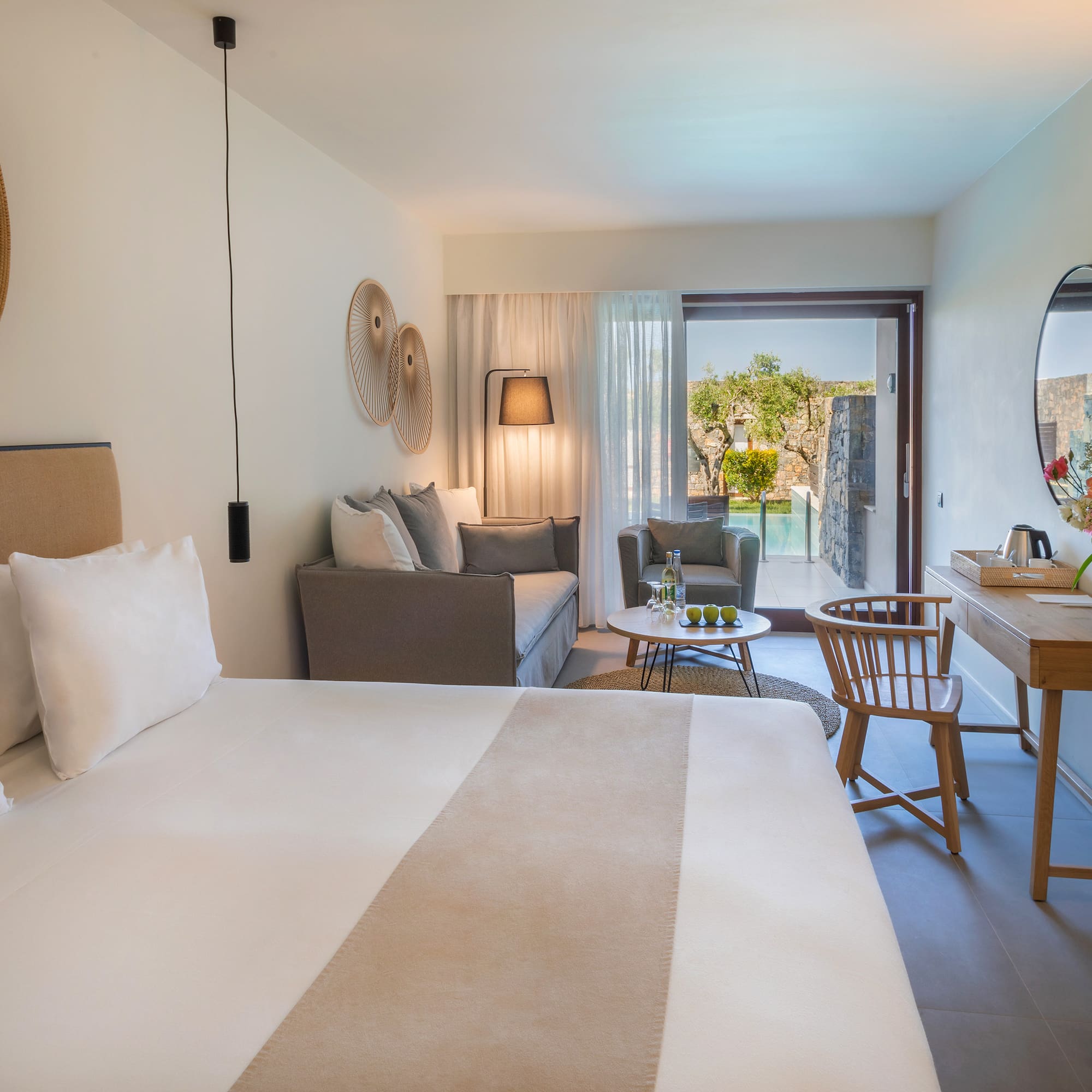 a room with a bed and a table and chair