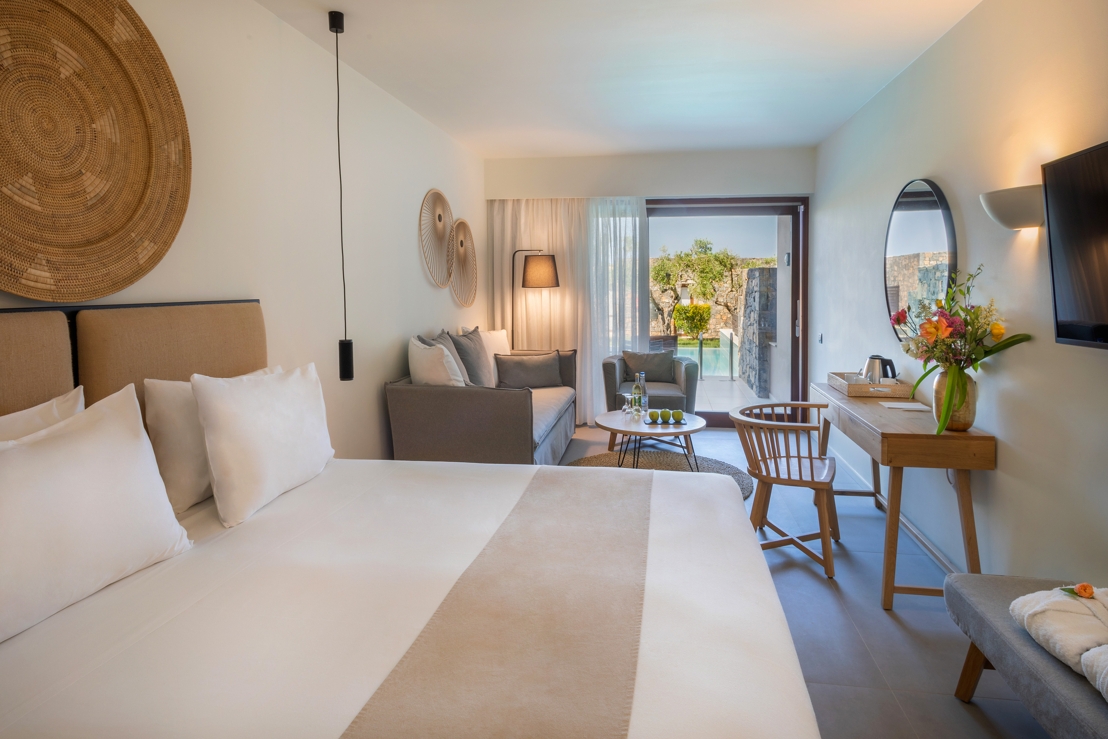 a room with a bed and a table and chair