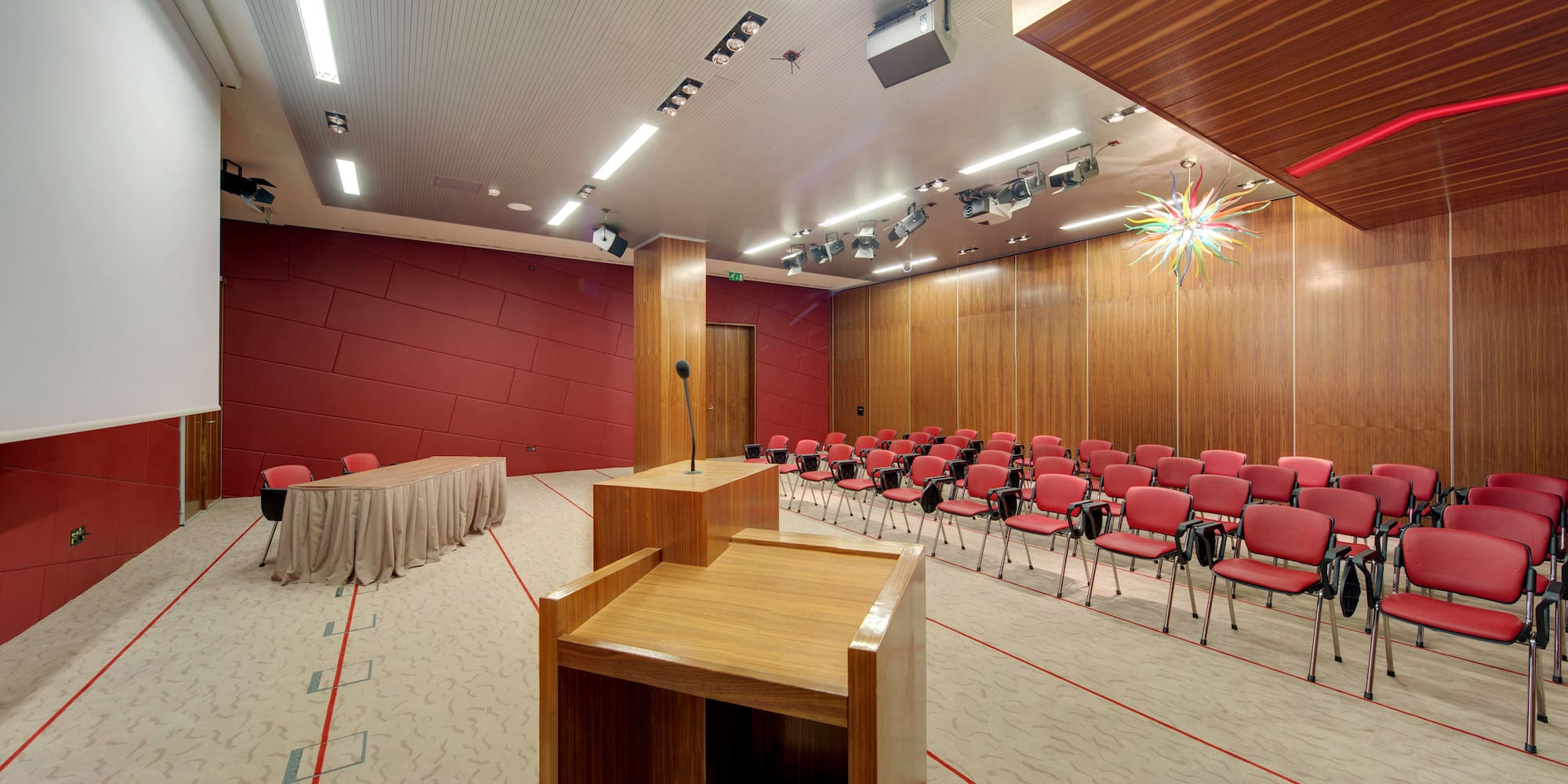 a room with a podium and chairs