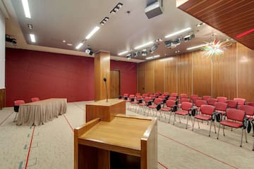 a room with a podium and chairs
