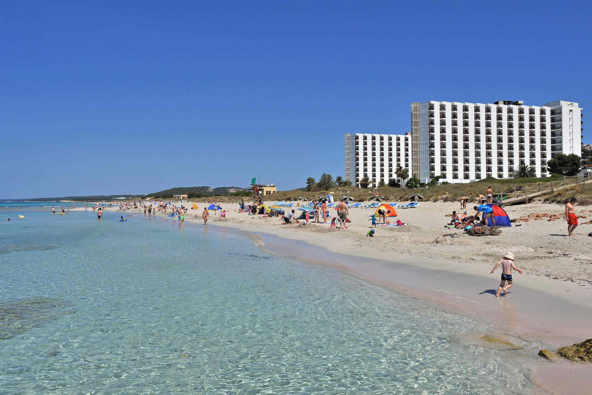 a beach with people and water with Clearwater Beach in the background