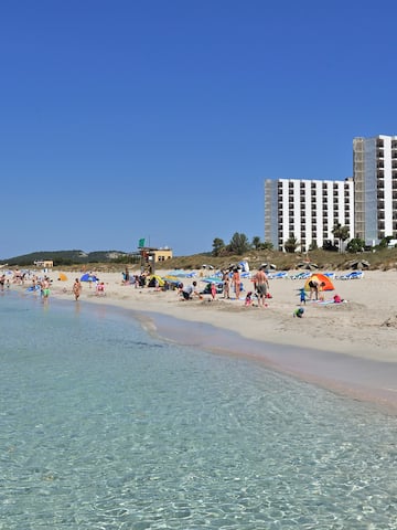 a beach with people and water with Clearwater Beach in the background