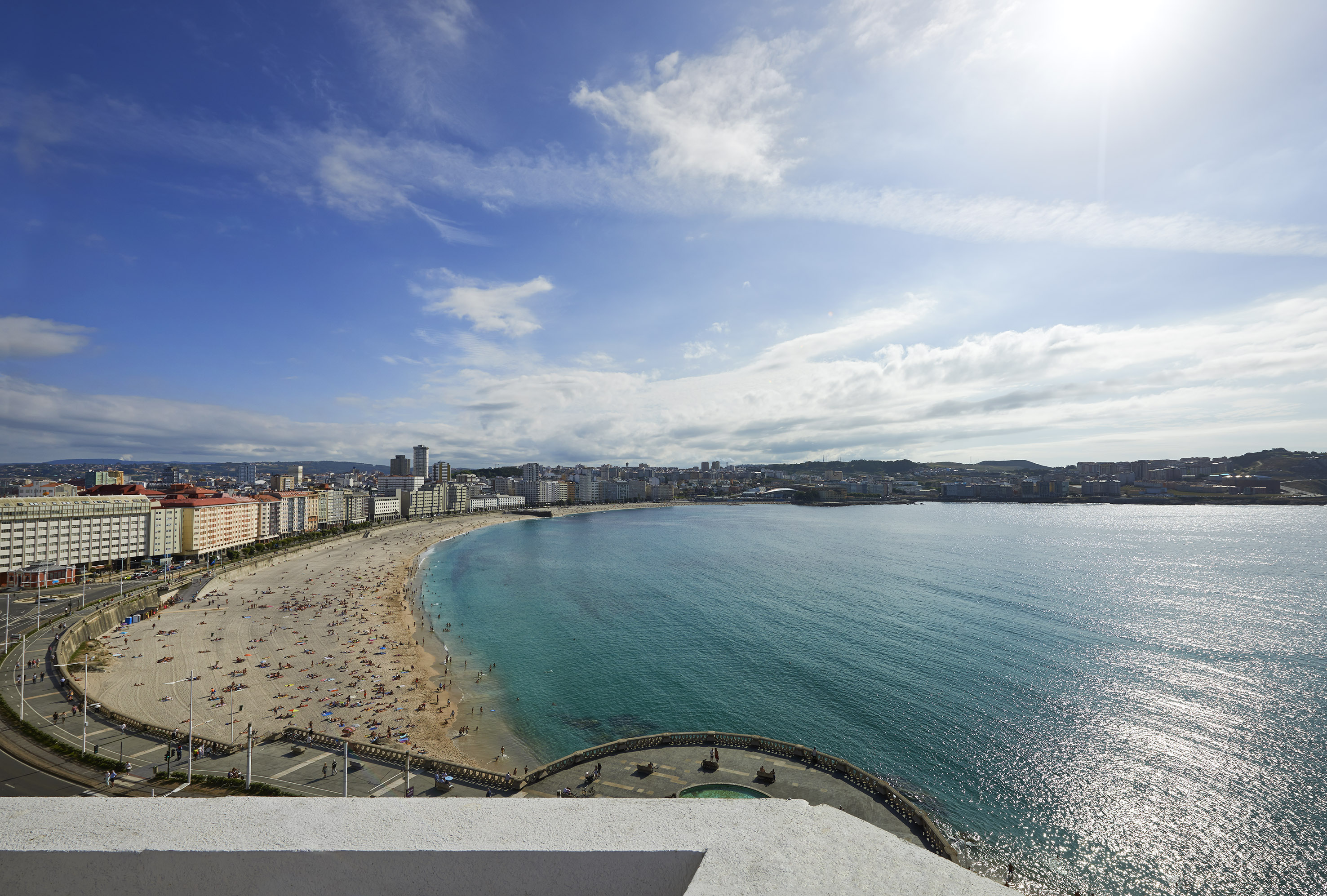 a beach with buildings and water
