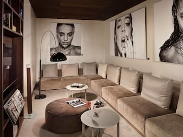 a living room with a couch and pictures on the wall