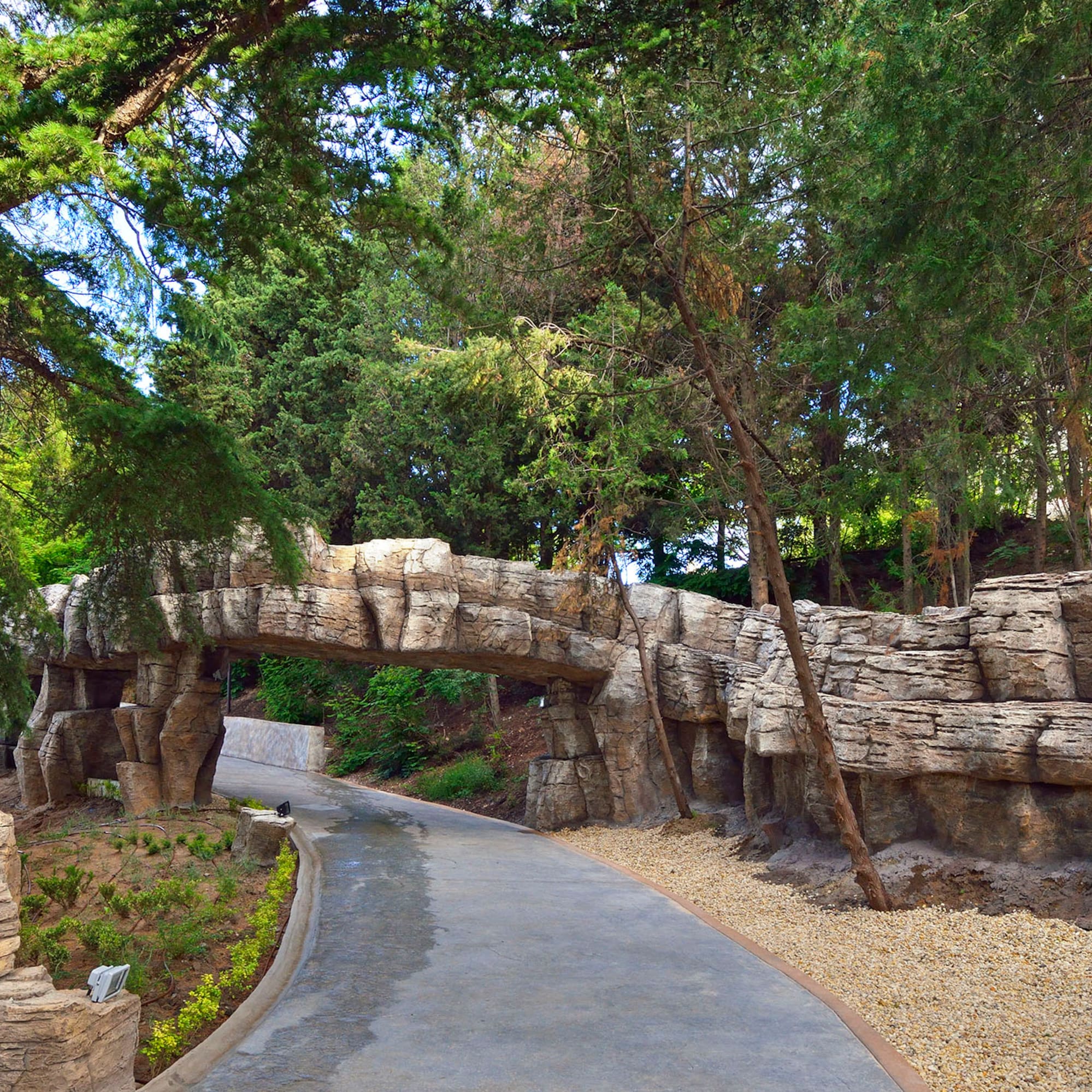 a stone bridge over a walkway