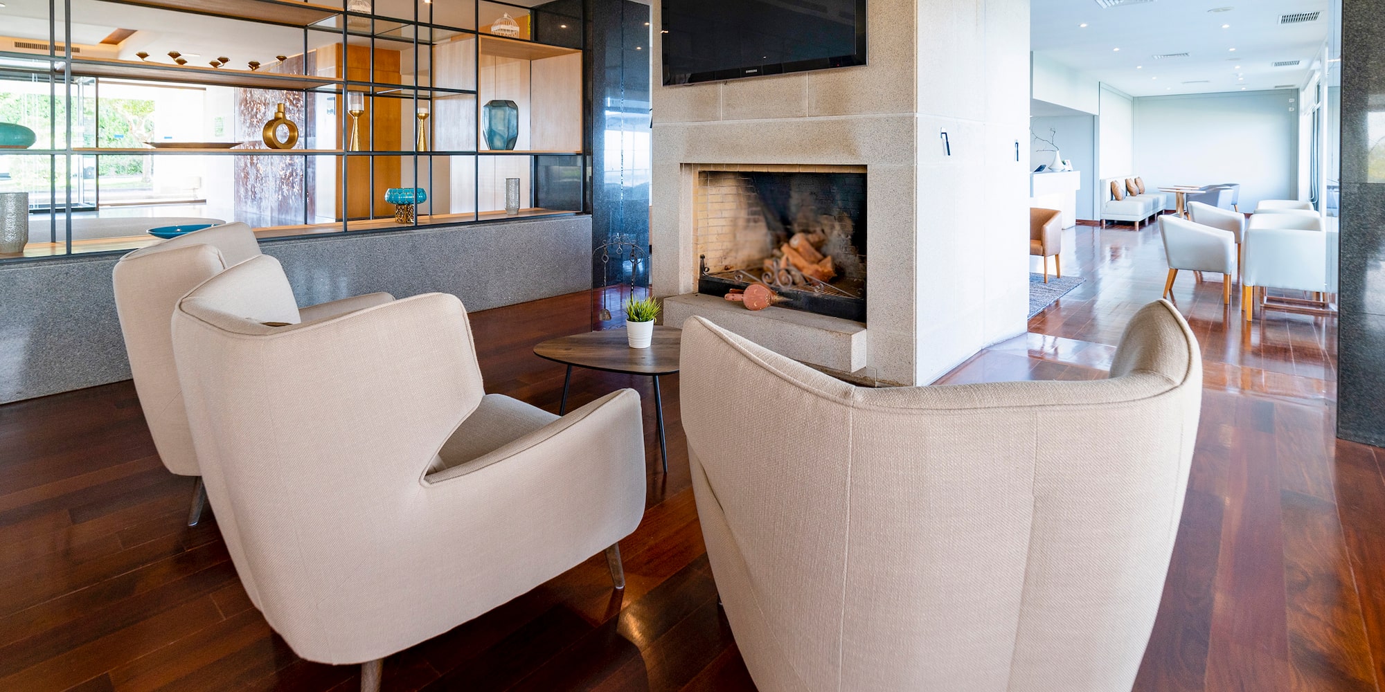 a room with a fireplace and chairs