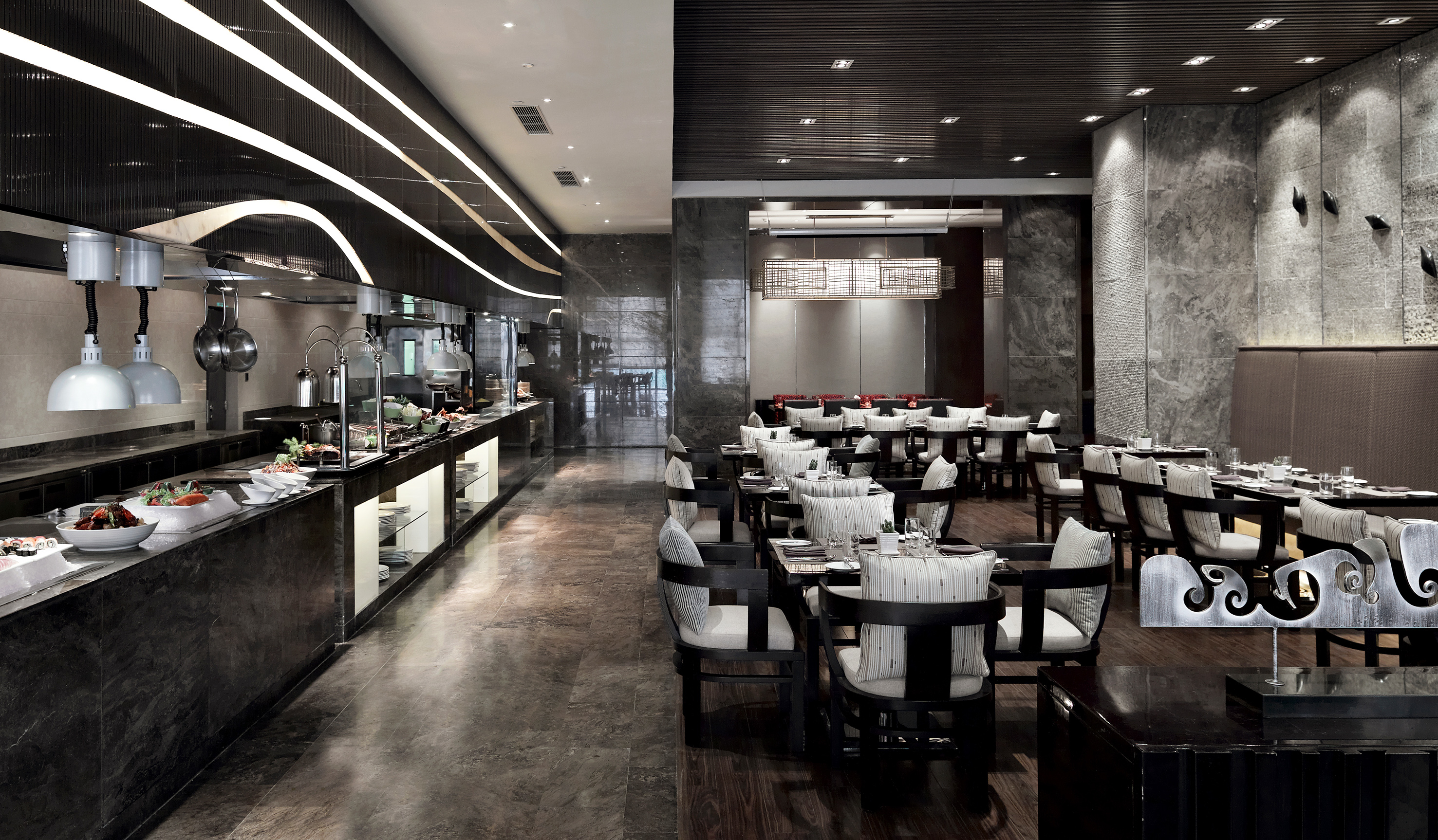 Luxury restaurant with modern buffet display and elegant dining tables.