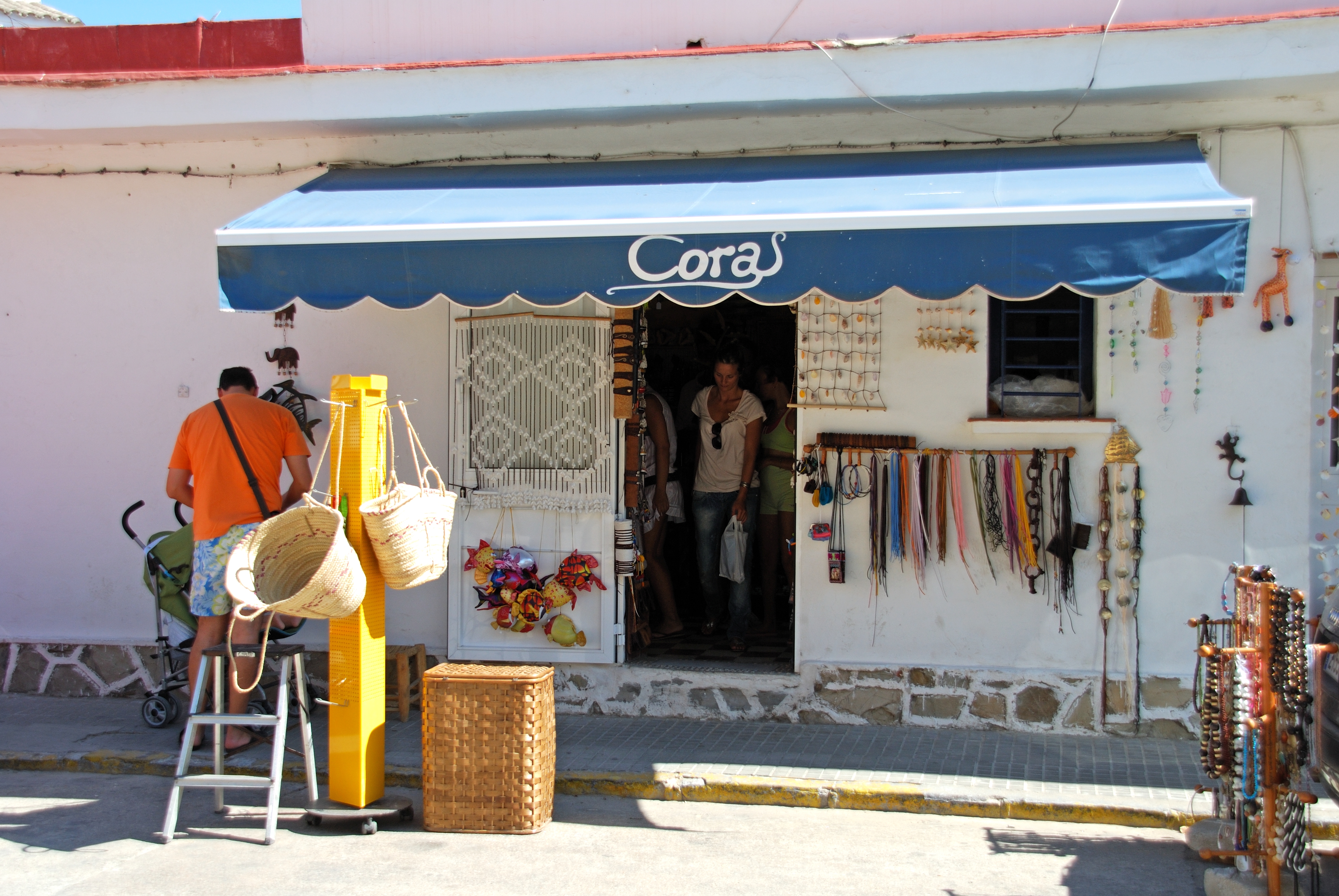 a store front with people standing in the doorway