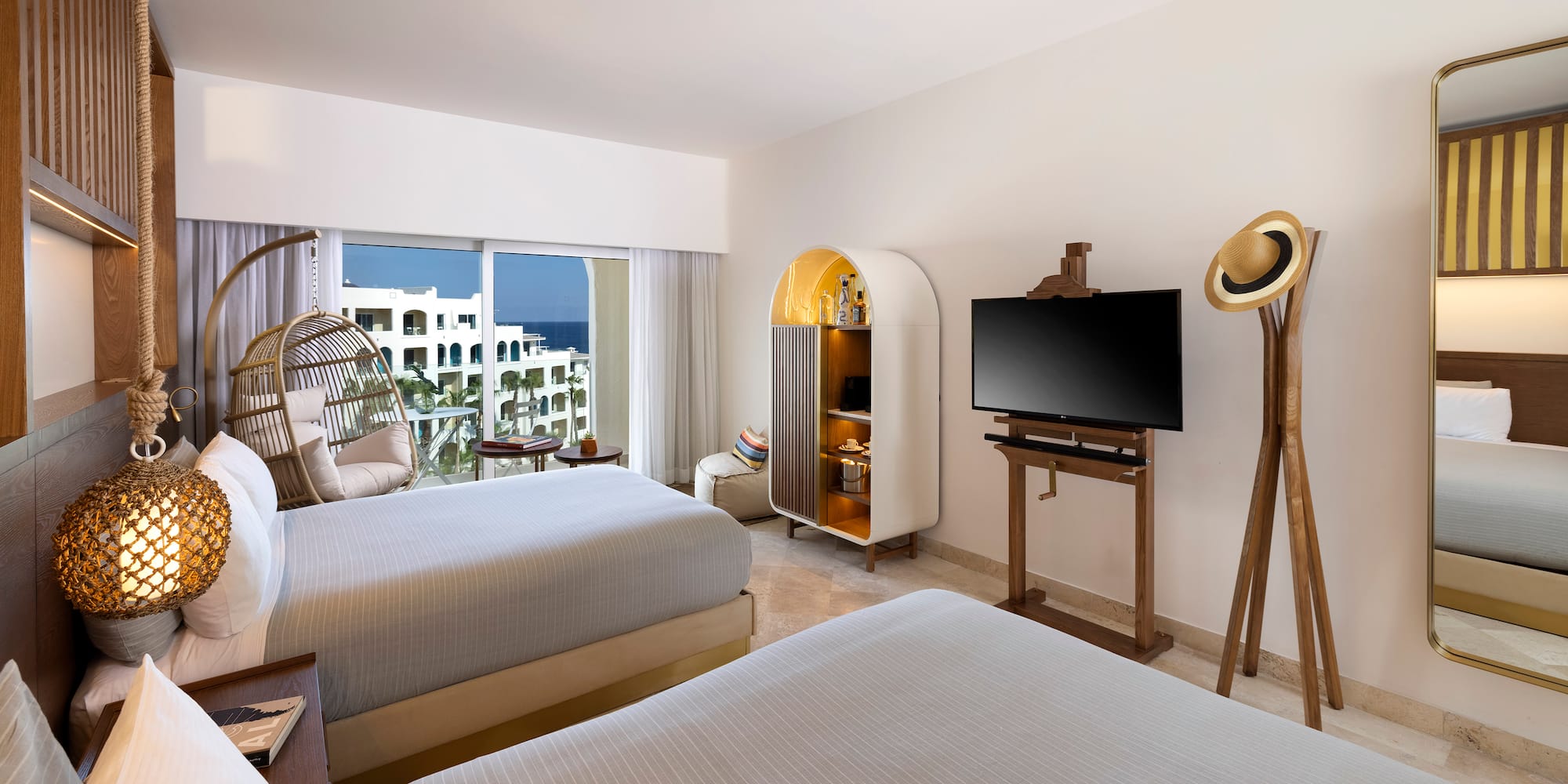 a room with two beds and a television