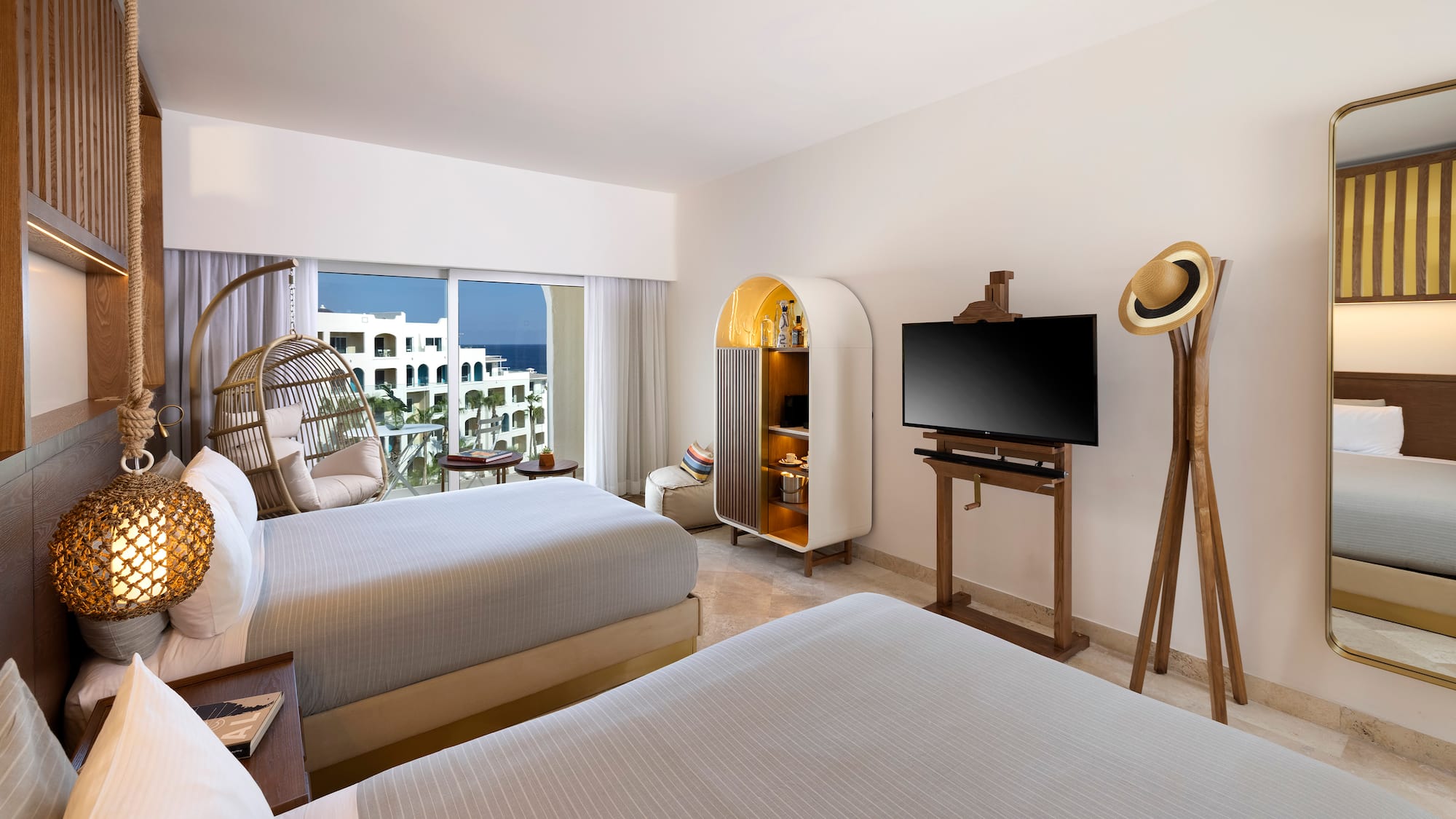 a room with two beds and a television