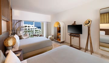 a room with two beds and a television