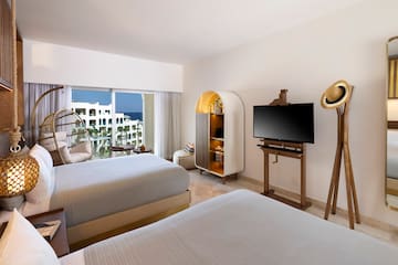 a room with two beds and a television